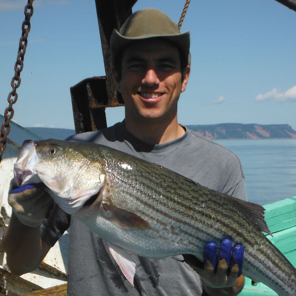 Mat, with a Striped Bass tl_files/sites/cel/Our Team Photos/MatBass.JPG